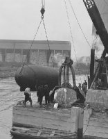 10:45 a.m. .. the Tym-Barge is lowered into the Chicago River at the facilities of the Great Lakes Dredge and Dock Company at 1902 West Branch Street, Chicago.
